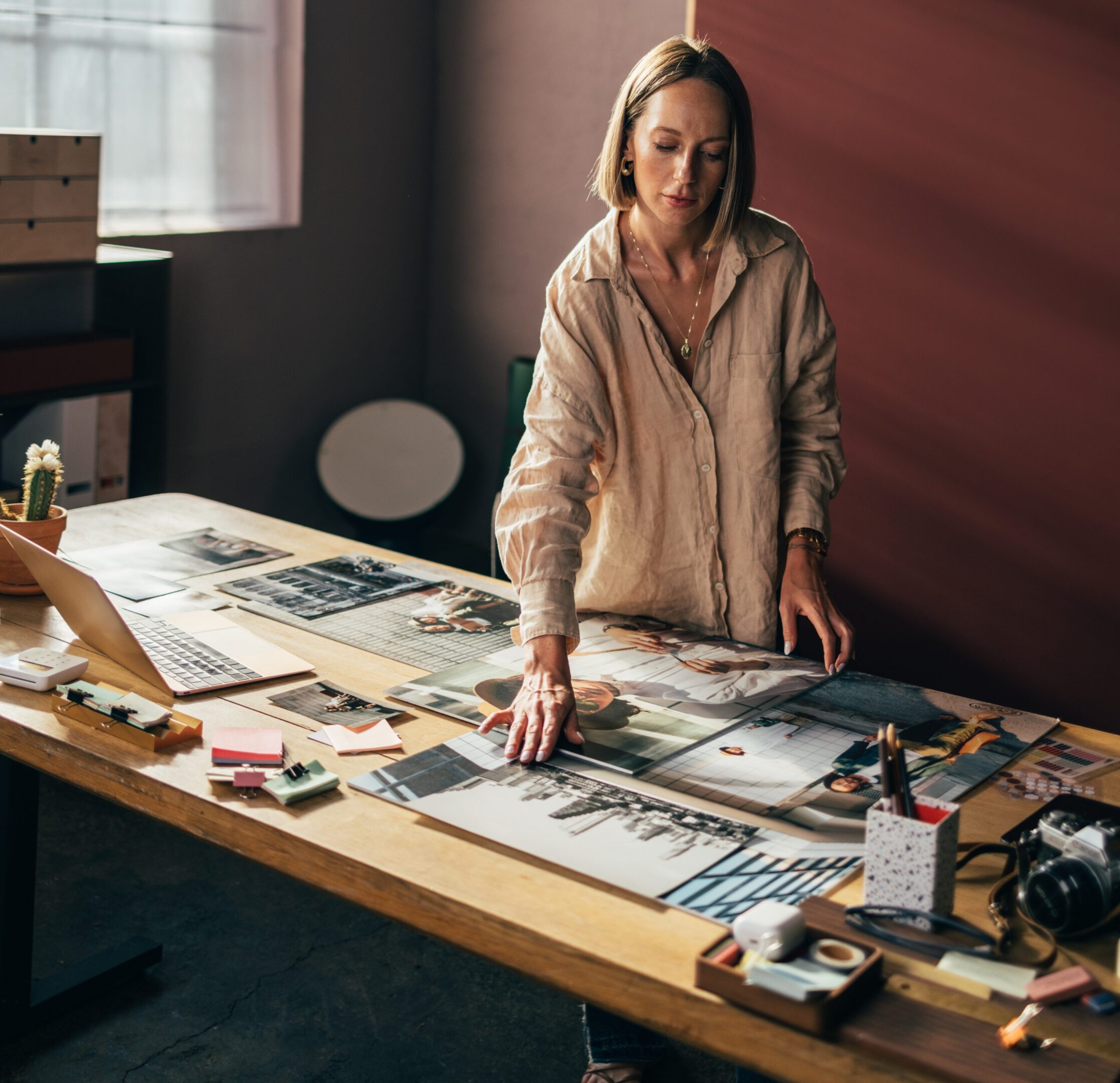 Artist arranging photos and supplies